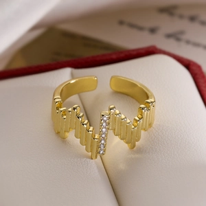Minimalist gold-plated wave ring with zircon stones in a red jewelry gift box