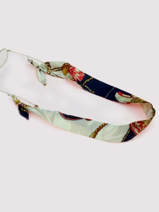Close-up of silk printed eyeglass chain with navy and gold patterns and rubber loops