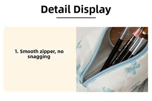 Internal view of a quilted bow makeup bag showing smooth zipper and storage space