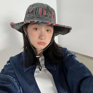 Dark grey ethnic wide brim bucket hat with colorful ribbon and adjustable chin strap