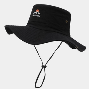 Detail of outdoor sun hat with embroidered mountain logo and adjustable chin strap