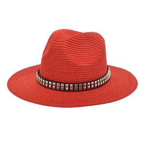 Close-up of a dark red woven straw fedora featuring a black studded leather band