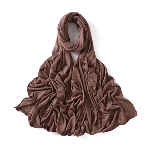 Detail of dark brown modal jersey scarf showing soft draped fabric and fine hemmed edges
