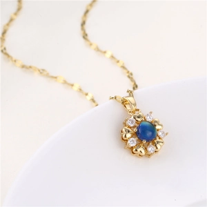 Gold-plated heart pendant necklace with blue color-changing stone and small zircons