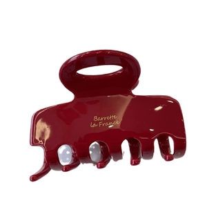 Elegant deep red acetate hair claw clip with golden Barrette la France script on white back