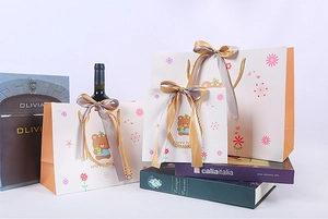 Three sizes of cartoon bear gift bags with silk ribbons and orange accents