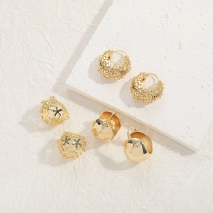 Detailed view of 14K gold plated earrings set with geometric zircon and woven texture