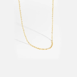 Close-up of a delicate golden S925 silver heart pendant necklace on a fine chain