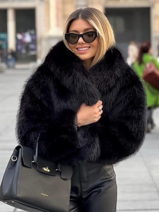 Elegant black faux fox fur short jacket with collar for women in a stylish city street view