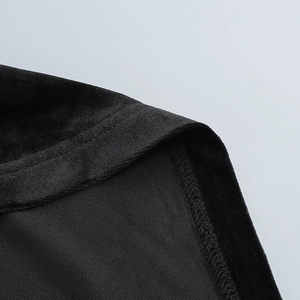 Detailed close-up showing the premium velvet texture and fine stitching on the black dress
