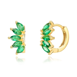 Close-up of gold hoop earrings with marquise-cut green stones and claw setting detail