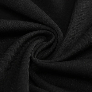 Detailed close-up of smooth black knit fabric texture for slim fit fishtail evening gown