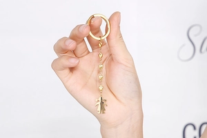 Golden heart chain keychain with female figurine charm on long metallic link chain