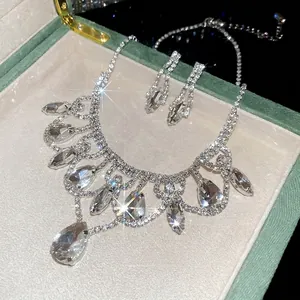 Luxury silver-tone jewelry set featuring crystal teardrop pendant necklace and earrings