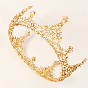 Luxurious gold floral bridal crown with vintage baroque rhinestones on a clean background