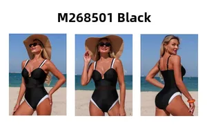 Three-way view of black one-piece swimsuit with mesh panels and contrast straps on beach