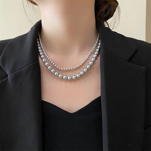 Close-up of double-layer grey pearl necklace on model with elegant French vintage style