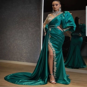 Elegant emerald green sequined evening gown with high slit and cathedral train