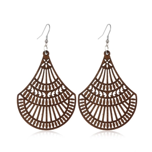 Detailed view of hollowed wood drop earrings with intricate floral pattern and brown finish
