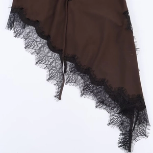 Brown blouse hem with delicate black eyelash lace trim detail and asymmetric fabric stitching