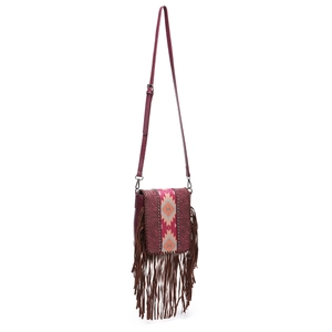 Detail of bohemian red crossbody bag featuring ethnic weave pattern and brown tassels