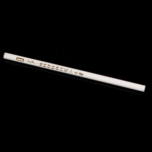 Detail of white diamond dotting pen with gold lettering on a black background