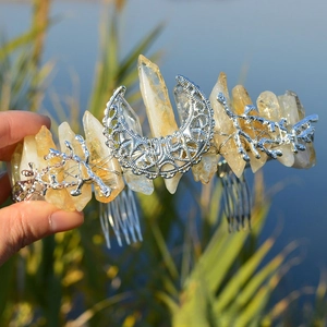 Detailed view of yellow quartz crystals with silver moon and twig accents on a crown