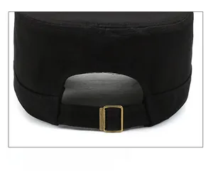 Detail of adjustable metal buckle on black military flat top cap with fabric texture