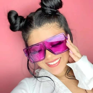 Oversized trendy square sunglasses with transparent purple frame on a fashion model