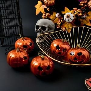 Set of 5 metallic orange Halloween pumpkin ornaments in a festive decorative scene