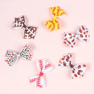 Detailed view of six ribbon bow hair clips with rugby and baseball sports patterns