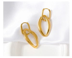 Detail of 18K gold-plated irregular geometric nested hoop earrings on white silk