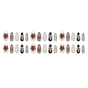 3D floral relief press-on nails with brown gradient and polka dot patterns on long almond shape