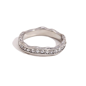 Irregular wavy silver ring with full cubic zirconia stones on white background
