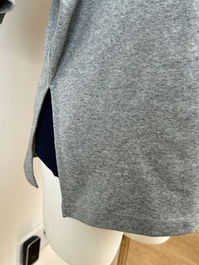 Close-up of grey waffle knit cotton t-shirt featuring a side slit design and soft texture