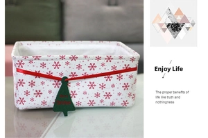 Detail of Christmas storage bin with red snowflake pattern and Merry Christmas tree tag