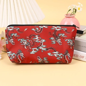 Minimalist red travel makeup bag with traditional dragon pattern and black zipper