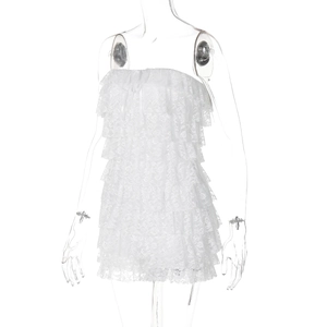 Close-up detail of tiered white floral lace fabric on strapless mini dress