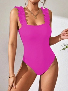 Detail of fuchsia ribbed bodysuit featuring elegant ruffled wide shoulder straps