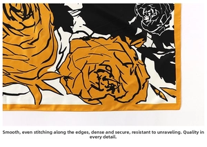 Detailed macro view of the neat hemmed edge and fabric texture on a floral silk scarf