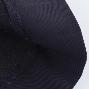 Detail shot of the tight knit fabric texture and durable overlock stitching on the black dress
