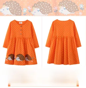 Detail of orange long sleeve girl dress with white polka dots and hedgehog embroidery