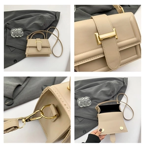 Detail view of beige square bag showing gold magnetic closure and strap attachments