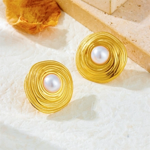 French vintage 18K gold plated spiral earrings with pearls on a natural stone background