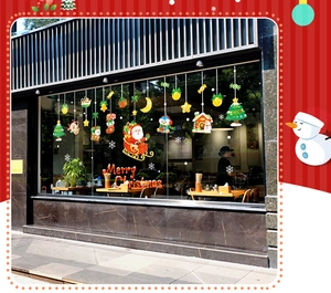 Detail of Christmas window stickers featuring Santa, snowman and Merry Christmas lettering