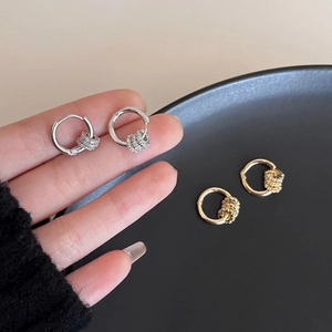 Detailed close-up of 18k gold and silver plated hoop earrings with zircon pendants