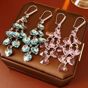 Detail of pink and blue heart tassels with zircon studs on a luxury jewelry box