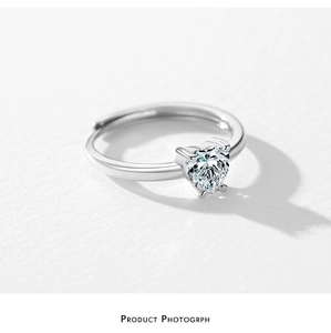 Close-up of S925 sterling silver heart ring with sparkling cubic zirconia on white background