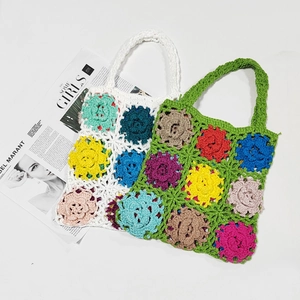 Detail of handmade crochet tote bag featuring multi-colored 3D floral patchwork patterns