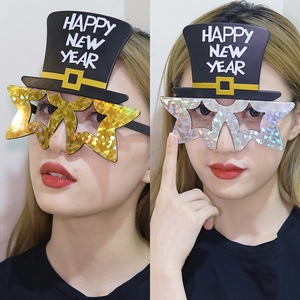 Gold and silver Happy New Year party glasses with top hats and holographic star frames